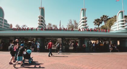 Visitors at Disney California Adventure Park entrance in Anaheim, a popular family destination.