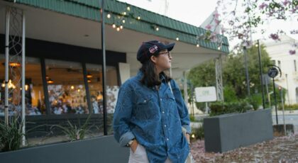 Fashionable woman in Merida, Yucatan urban scene, wearing a blue shirt and cap.