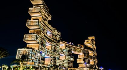 Stunning view of the illuminated Atlantis The Royal Hotel in Dubai, showcasing its modern architecture against the night sky.