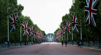 The Mall in London decorated with British flags, leading to Buckingham Palace.