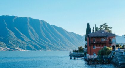 Lakeside hotel with scenic mountain views at Lake Como, Italy, showcasing serene beauty.