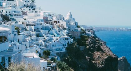 Breathtaking view of Santorini's iconic whitewashed buildings perched on a cliff overlooking the sea.