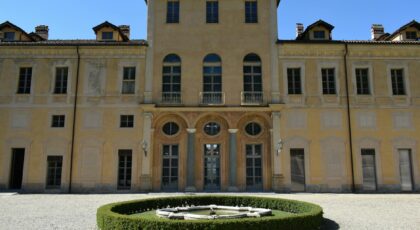 Beautiful facade of an Italian villa in Turin, showcasing classic architecture and manicured garden.