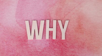Bold white letters spelling WHY on a pink textured background for conceptual design.